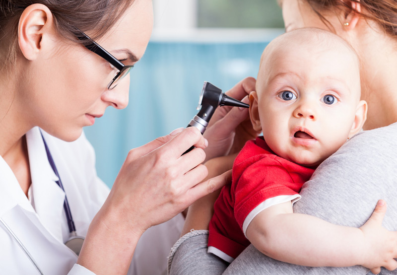 Examining-baby-for-congenital-atresia-of-the-ear