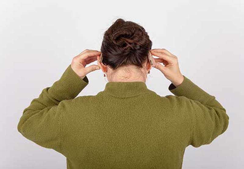 Woman-trying-bone-anchored-hearing-aids Woman-trying-bone-anchored-hearing-aids